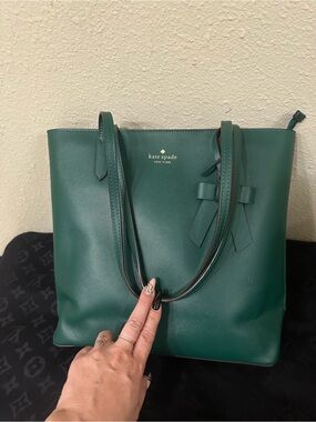 Kate Spade deep jade green color with a bow dangle.